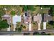 Overhead view displaying the house with its unique roof design, surrounded by neighboring homes and mature trees at 834 Riverside Dr, Tarpon Springs, FL 34689