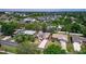 Overhead view of the home in a neighborhood with lakes in the distance and many mature trees at 834 Riverside Dr, Tarpon Springs, FL 34689
