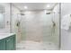 Luxurious bathroom featuring a large, glass-enclosed shower with dual shower heads and gold fixtures at 834 Riverside Dr, Tarpon Springs, FL 34689