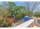 View from deck area showing mature trees, lush foliage and a view of the surrounding neighborhood at 834 Riverside Dr, Tarpon Springs, FL 34689