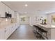 Bright kitchen boasts white cabinets, marble countertops, stainless steel appliances, and a large island with bar seating at 834 Riverside Dr, Tarpon Springs, FL 34689