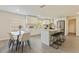 Bright kitchen featuring white cabinets, granite counters, a modern island, and stainless steel appliances at 834 Riverside Dr, Tarpon Springs, FL 34689