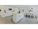 Well-designed kitchen has an island, stainless appliances, white cabinetry, dining area, and an open floor plan at 834 Riverside Dr, Tarpon Springs, FL 34689