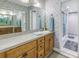 Bright bathroom with a long countertop, ample storage, and a clear view of the shower area at 8681 Bardmoor Blvd # 208C, Seminole, FL 33777