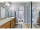 Well-lit bathroom featuring a long vanity with a sink and mirrored sliding closet doors at 8681 Bardmoor Blvd # 208C, Seminole, FL 33777