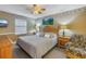 Relaxing bedroom with a plush bed, ceiling fan, and cozy decor at 8681 Bardmoor Blvd # 208C, Seminole, FL 33777