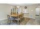Cozy dining room with wooden table, chairs, chandelier, and tile flooring at 8681 Bardmoor Blvd # 208C, Seminole, FL 33777