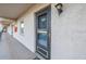 Exterior unit entrance with visible unit number and a well-maintained walkway at 8681 Bardmoor Blvd # 208C, Seminole, FL 33777