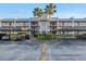 Exterior shot of condo building featuring covered parking, balconies, and neatly kept grounds at 8681 Bardmoor Blvd # 208C, Seminole, FL 33777