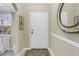 Bright foyer features neutral walls, tiled floor and a decorative mirror accent at 8681 Bardmoor Blvd # 208C, Seminole, FL 33777