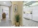 Open concept kitchen with white cabinets, tiled floors, and connection to the living area at 8681 Bardmoor Blvd # 208C, Seminole, FL 33777