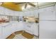 Bright kitchen featuring white appliances, tiled countertops, and ample cabinet space at 8681 Bardmoor Blvd # 208C, Seminole, FL 33777