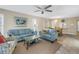 Open-concept living room with sofas, coffee table, dining area, and abundant natural light at 8681 Bardmoor Blvd # 208C, Seminole, FL 33777