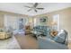 Inviting living room with plush sofas, ceiling fan, and sliding doors to the outside at 8681 Bardmoor Blvd # 208C, Seminole, FL 33777