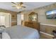 Serene main bedroom with a comfortable bed, dresser, and a view of the bathroom at 8681 Bardmoor Blvd # 208C, Seminole, FL 33777