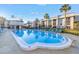 Outdoor swimming pool with seating surrounded by condominiums and palm trees at 8681 Bardmoor Blvd # 208C, Seminole, FL 33777