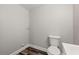Compact bathroom with a toilet, vanity, and modern fixtures in a neutral color scheme at 924 N Castle Ct, Tampa, FL 33612