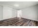 Clean bedroom with wood-look flooring, white walls, and built-in closet offering ample storage space at 924 N Castle Ct, Tampa, FL 33612