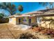 Quaint home with a decorative metal porch, front yard landscaping, and unique architectural details at 924 N Castle Ct, Tampa, FL 33612