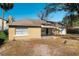 Exterior shot of a one-story home with a palm tree, fenced in backyard, and attached garage at 924 N Castle Ct, Tampa, FL 33612