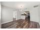 Open living room with hardwood floors, brick archway, and modern lighting at 924 N Castle Ct, Tampa, FL 33612
