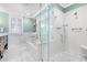 Bright bathroom featuring a modern glass-enclosed shower and a soaking tub with chrome fixtures at 929 S Oregon Ave, Tampa, FL 33606