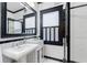 Bright bathroom with a black and white color scheme, framed mirror, and glass shower at 929 S Oregon Ave, Tampa, FL 33606