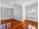 Bright bedroom featuring hardwood floors, white walls, and multiple windows at 929 S Oregon Ave, Tampa, FL 33606