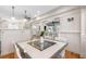 A dining room featuring hardwood floors, white walls, and views into other rooms at 929 S Oregon Ave, Tampa, FL 33606