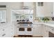 Kitchen featuring white cabinetry, stainless steel appliances, and a pass through to the dining room at 929 S Oregon Ave, Tampa, FL 33606