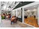 Covered outdoor patio featuring tile flooring, seating, ceiling fans, and an entryway into the home at 929 S Oregon Ave, Tampa, FL 33606