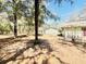 Spacious backyard showcasing the home's exterior, deck, and mature trees, creating a private retreat at 9377 Preston Rd, Brooksville, FL 34601