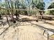 View of the wooden deck that overlooks the wooded backyard at 9377 Preston Rd, Brooksville, FL 34601