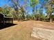 Expansive backyard with mature trees offering shade and privacy with a screened in porch at 9377 Preston Rd, Brooksville, FL 34601