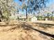 Home's backyard with shade trees on a sunny day at 9377 Preston Rd, Brooksville, FL 34601