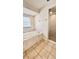 Bright bathroom featuring a soaking tub, walk-in shower, and tiled walls at 9377 Preston Rd, Brooksville, FL 34601