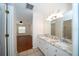 Bathroom with double vanity, granite countertop, tile flooring, and lighting at 9377 Preston Rd, Brooksville, FL 34601