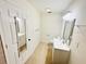 Bathroom with tile floors, toilet, vanity and sink, and mirror at 9377 Preston Rd, Brooksville, FL 34601