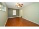 Bedroom with hardwood floors, a ceiling fan, and natural light from two windows at 9377 Preston Rd, Brooksville, FL 34601