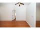 Spacious bedroom with hardwood floors, high ceiling, and a ceiling fan for added comfort at 9377 Preston Rd, Brooksville, FL 34601