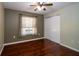Cozy bedroom featuring hardwood floors, a ceiling fan, and a closet with sliding doors at 9377 Preston Rd, Brooksville, FL 34601