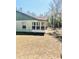 Side view of the home's exterior with a view of the yard and a screened patio at 9377 Preston Rd, Brooksville, FL 34601