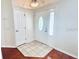 A classic foyer with a tile inset, hardwood floors, and white doors at 9377 Preston Rd, Brooksville, FL 34601