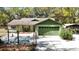 Charming single-story home featuring an attached garage, a lush lawn, and mature trees, perfect for suburban living at 9377 Preston Rd, Brooksville, FL 34601
