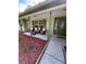 Inviting front porch with comfortable seating and charming curb appeal with fresh mulch and landscaping at 9377 Preston Rd, Brooksville, FL 34601