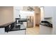 Modern kitchen with stainless steel appliances, granite countertops, white cabinets and tiled floor at 9377 Preston Rd, Brooksville, FL 34601