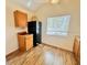 Efficient kitchenette including dark appliances, light wood cabinets, and a window with backyard views at 9377 Preston Rd, Brooksville, FL 34601