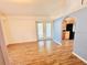 Open-concept living room showcasing hardwood floors, neutral walls, and an archway leading to the kitchen at 9377 Preston Rd, Brooksville, FL 34601