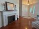 Bright living room featuring a fireplace, hardwood floors, and a grand entrance with stained glass windows at 9377 Preston Rd, Brooksville, FL 34601