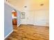 Cozy living area with wood floors, light blue accent walls, and neutral walls at 9377 Preston Rd, Brooksville, FL 34601